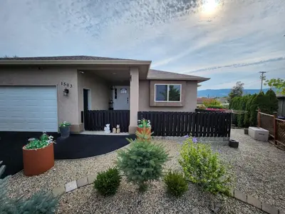 a small house with a fence in front of it at Kelowna full level luxury-BIG white ski 35 mins in Kelowna