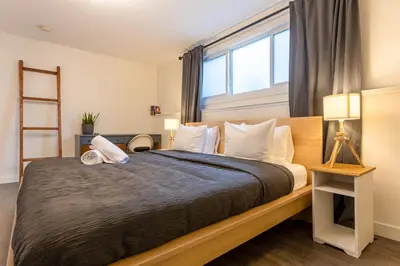 a bedroom with a large bed with a large window at Elkview by Fernie Central Reservations in Fernie
