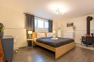 a bedroom with a large bed and a window at Elkview by Fernie Central Reservations in Fernie
