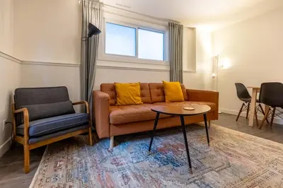 a living room with a couch and a table at Elkview by Fernie Central Reservations in Fernie