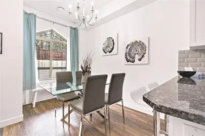 a dining room with a glass table and chairs at Marvellous Poolside Chalet - Pool & Hot Tub - Pets in Canmore