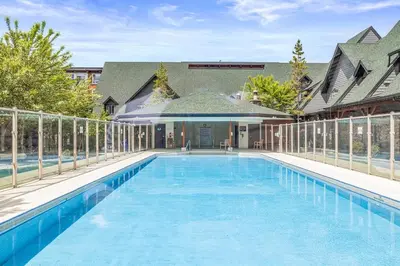 a large swimming pool in the backyard of a house at Marvellous Poolside Chalet - Pool & Hot Tub - Pets in Canmore
