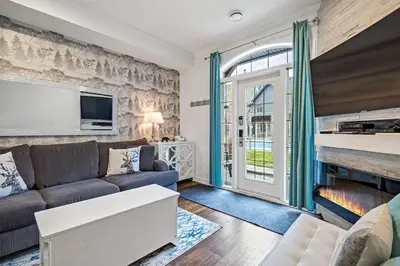 a living room with a couch and a fireplace at Marvellous Poolside Chalet - Pool & Hot Tub - Pets in Canmore