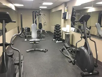 a gym with several treadmills and exercise bikes at Stunning Condo - Hot Tubs & Steam Room - Pets Ok in Canmore