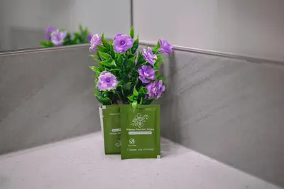 a green vase with purple flowers sitting on a counter at Rockies Retreat Getaway Heated Pool &Hot Tub Gym in Dead Man's Flats