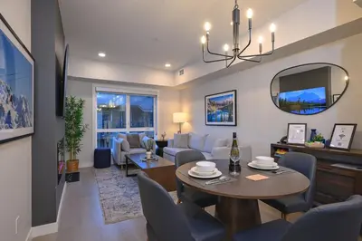 a living room with a couch and a table at Rockies Retreat Getaway Heated Pool &Hot Tub Gym in Dead Man's Flats