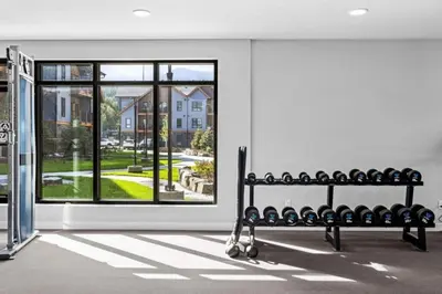 a room with a bench in front of a window at Rockies Retreat Getaway Heated Pool &Hot Tub Gym in Dead Man's Flats