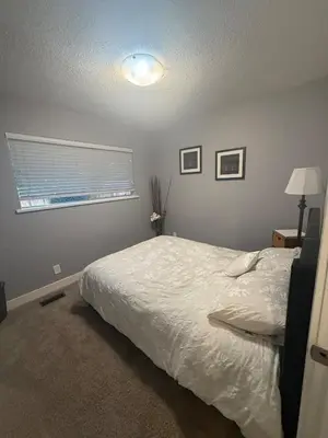 a bedroom with a white bed and a window at The Sunshine Haven in Delta