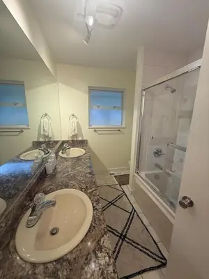 a bathroom with two sinks and a shower at The Sunshine Haven in Delta