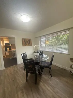 a dining room with a glass table and chairs at The Sunshine Haven in Delta