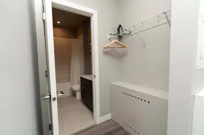 a white bathroom with a toilet and a shower at Corporate Stays Village on 105 1 Bedroom in Edmonton