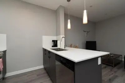 a kitchen with a sink and a counter top at Corporate Stays Village on 105 1 Bedroom in Edmonton