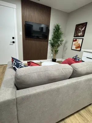 a couch in a living room with a flat screen tv at NorthEdge Suites in Edmonton