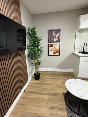 a room with a table and a potted plant at NorthEdge Suites in Edmonton