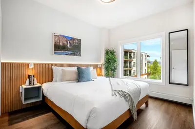 a bedroom with a large bed and a window at New 2BR in DT Golden with AC, Balcony, BBQ, Sleeps 6 in Golden