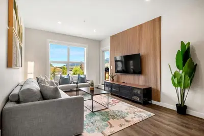 a living room with a couch and a tv at New 2BR in DT Golden with AC, Balcony, BBQ, Sleeps 6 in Golden