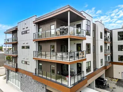an apartment building with balconies on it at New 2BR in DT Golden with AC, Balcony, BBQ, Sleeps 6 in Golden