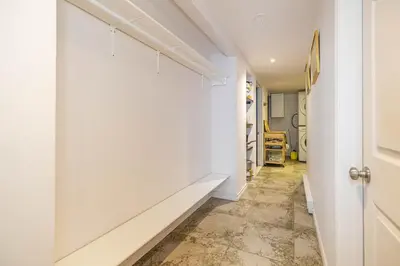 a hallway with white walls and tile floors at 2 BDRS at DT-Near 2 metros, Atwater Market, Concordia in Bélanger