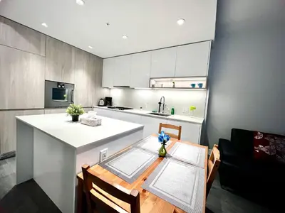 a kitchen with a table and a white counter top at Warm and Cozy 1B1B near Richmond center in Richmond