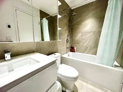 a bathroom with a toilet and a sink and a mirror at Warm and Cozy 1B1B near Richmond center in Richmond