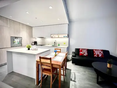 a kitchen and living room with a table and a couch at Warm and Cozy 1B1B near Richmond center in Richmond