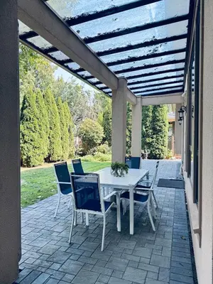 a patio with a white table and chairs under a pergola at Grace Sweet Homes Kingsize Bedroom NOT A PRIVATE HOUSE - SHARED AMENITIES in Richmond