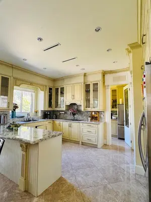 a large kitchen with white cabinets and a counter top at Grace Sweet Homes Kingsize Bedroom NOT A PRIVATE HOUSE - SHARED AMENITIES in Richmond