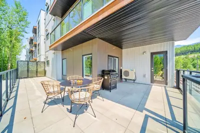 an outdoor patio with a table and chairs at Stylish 2BR Golden Getaway with BBQ and Stunning Views in Golden