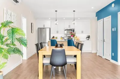 a kitchen and dining room with a wooden table and chairs at Stylish 2BR Golden Getaway with BBQ and Stunning Views in Golden