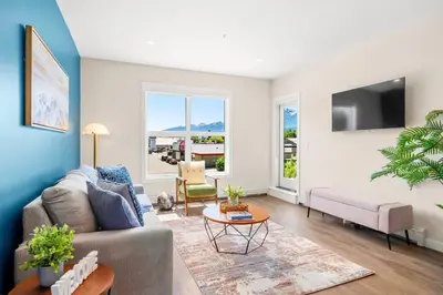 a living room with a couch and a table at Stylish 2BR Golden Getaway with BBQ and Stunning Views in Golden