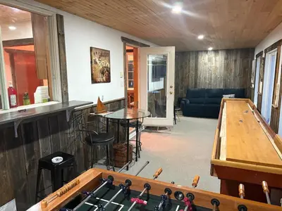 a living room with a ping pong table and a ping pong table at maison de la Ferme in Bélanger