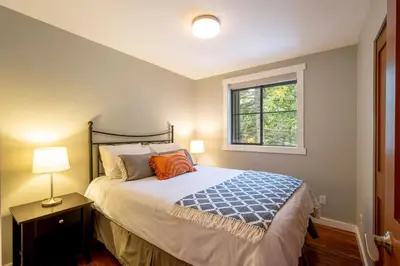 a bedroom with a bed and a window at Crystal Ridge by Whistler Retreats in Whistler