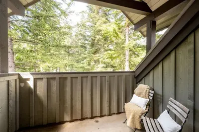 a screened porch with two chairs and a window at Crystal Ridge by Whistler Retreats in Whistler