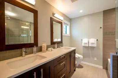 a bathroom with a sink and a toilet and a mirror at Crystal Ridge by Whistler Retreats in Whistler