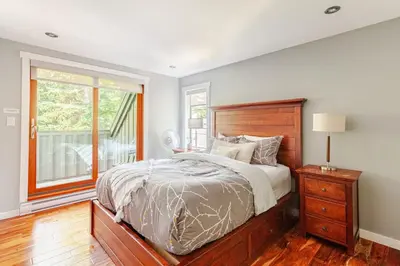 a bedroom with a large bed and a window at Crystal Ridge by Whistler Retreats in Whistler