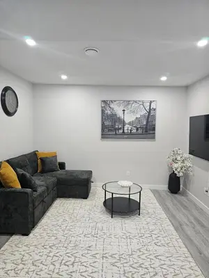 a living room with a couch and a table at Cozy on 516 in Airdrie