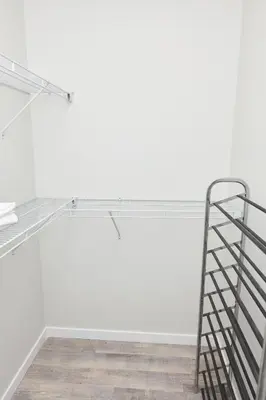 a glass shelf in a white room with a ladder at Anukc in Prince George