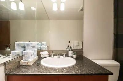 a bathroom with a sink and a mirror at Le Chamois 307 by Outpost Whistler in Whistler