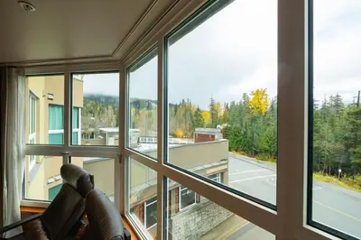 a room with a large window looking out onto a street at Le Chamois 307 by Outpost Whistler in Whistler