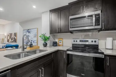 a kitchen with a sink and a microwave at The Herron Rise Retreat in Calgary