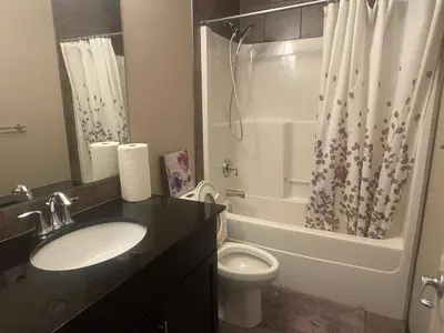 a bathroom with a sink and a toilet and a shower at Panorama Haven in Calgary