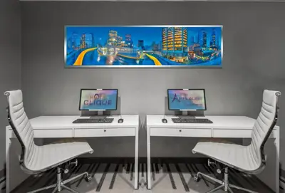 two desks with two computers on them in a room at Applause Hotel Calgary Airport by CLIQUE in Calgary