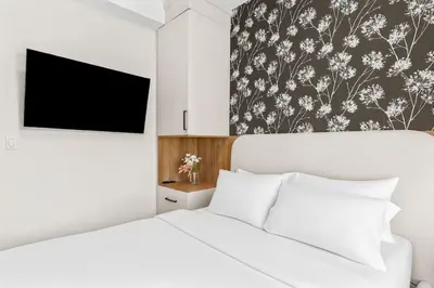 a bedroom with a white bed and a black and white wallpaper at 4BR Luxury Mountain Retreat Private HotTub Sleeps 17 in Canmore