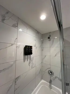 a bathroom with a shower and a bath tub at Cozy 2BR Retreat | Edmonton SW | Smart TV + Wi-Fi in Edmonton