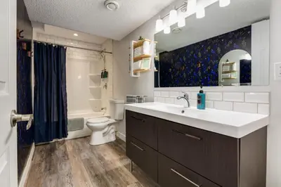 a bathroom with a sink and a toilet at Urban Retreat Suits 2 Bedroom & Feature Packed in Calgary