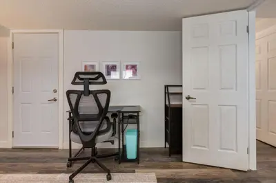 an office with a desk and a chair in a room at Urban Retreat Suits 2 Bedroom & Feature Packed in Calgary