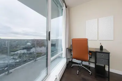 an office with a desk and a window at Sub-Penthouse Condo with Jacuzzi Pool Sauna & Gym in Vancouver