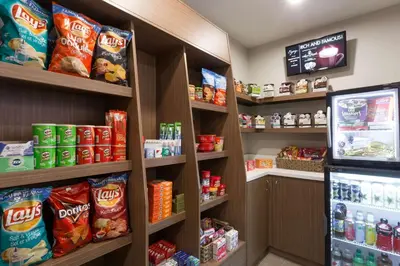 a grocery store aisle with shelves of chips and snacks at Microtel Inn and Suites by Wyndham Kitimat in Kitimat