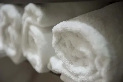 a pile of white towels on a towel rack at Microtel Inn and Suites by Wyndham Kitimat in Kitimat
