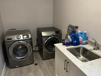 a kitchen with a washing machine and a sink at Nature Home Near Downtown and 17th Avenue in Calgary